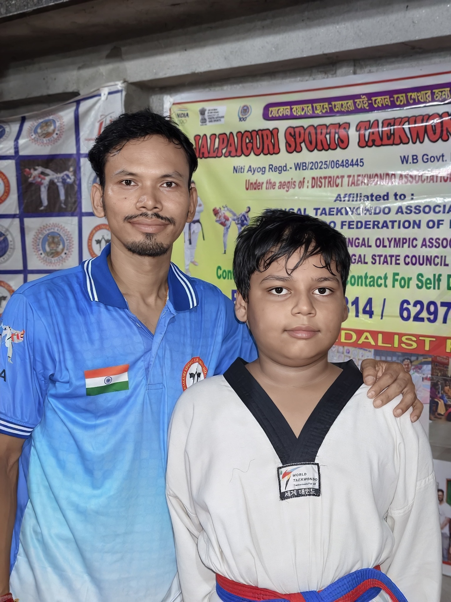 Coach and student in front of banner